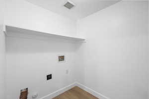 Laundry room with washer and dryer hookups, and LPV Luxury Vinyl flooring