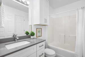 Full bathroom featuring a shower / bath combo with shower curtain, and a NEW vanity