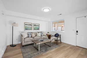 Living room featuring NEW LPV Luxury Vinyl flooring, and new paint