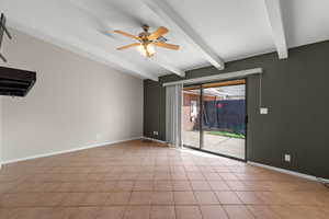 Empty room with ceiling fan and beam ceiling