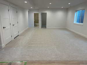 Unfurnished room with recessed lighting and baseboards