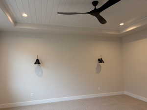 Unfurnished room with recessed lighting, cooling unit, a wood tray ceiling, light colored carpet, and a ceiling fan
