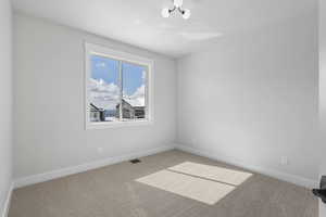 Unfurnished room with light carpet and baseboards