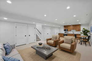 Enhanced photo-staged living room with recessed lighting and stairs