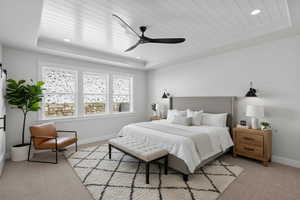 Enhanced staged photo. Bedroom with a wooden tray ceiling, light colored carpet, recessed lighting, and ceiling fan