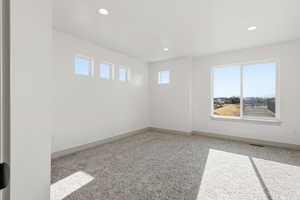 Spare room with light carpet and recessed lighting