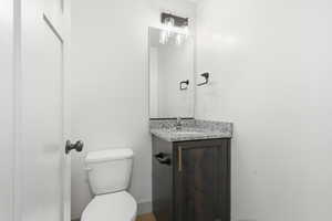 Half bathroom with vanity and toilet