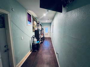 Hallway leading main bedroom, driveway and back yard