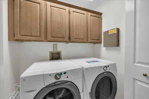 Laundry room featuring cabinet space and washer and dryer