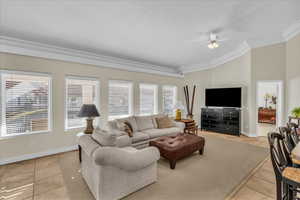 Living area with a ceiling fan, light tile patterned flooring, and vaulted ceiling