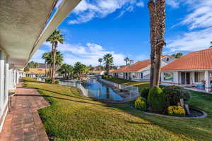 View of grassy yard featuring a patio and a residential view