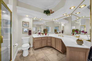 Bathroom featuring vanity, a shower stall, light tile patterned floors, recessed lighting, and ornamental molding
