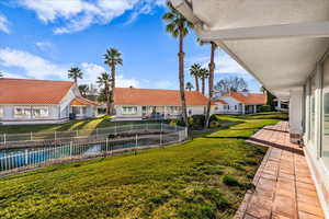 View of green lawn featuring a residential view