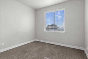 Unfurnished room with carpet and baseboards