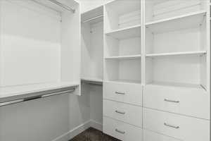 Walk in closet with dark carpet