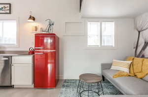 Living area with healthy amount of natural light and finished concrete flooring