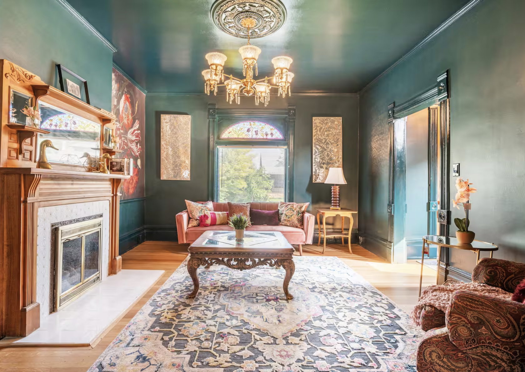 Sitting room featuring suspended lighting, a fireplace with flush hearth, and crown molding