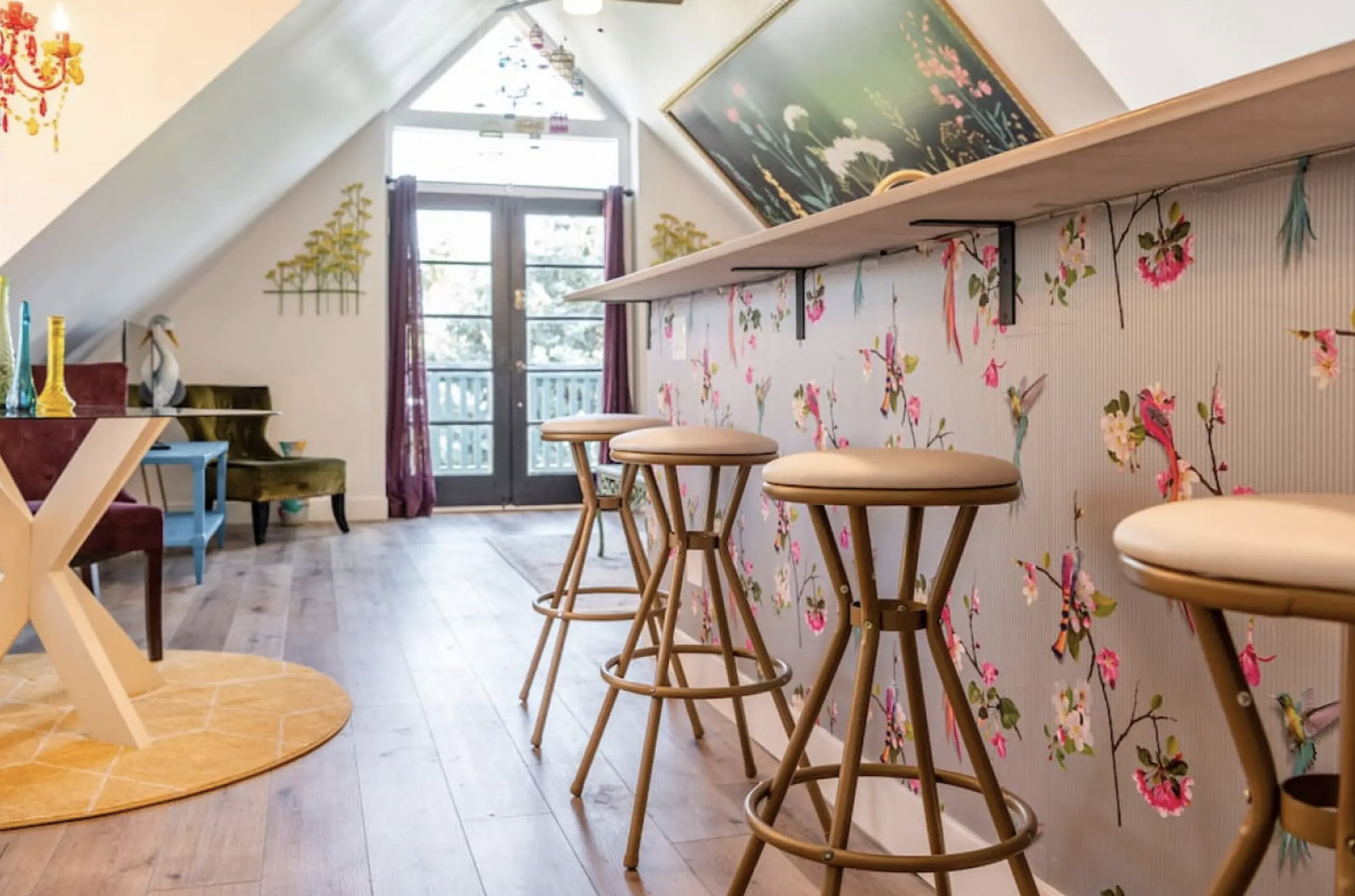 Bar featuring light wood finished floors, lofted ceiling, and french doors
