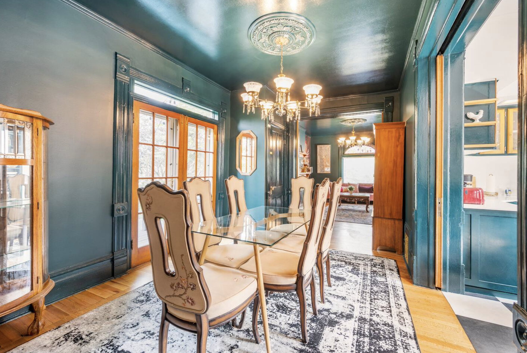 Dining space featuring hanging lights, wood finished floors, and ornamental molding