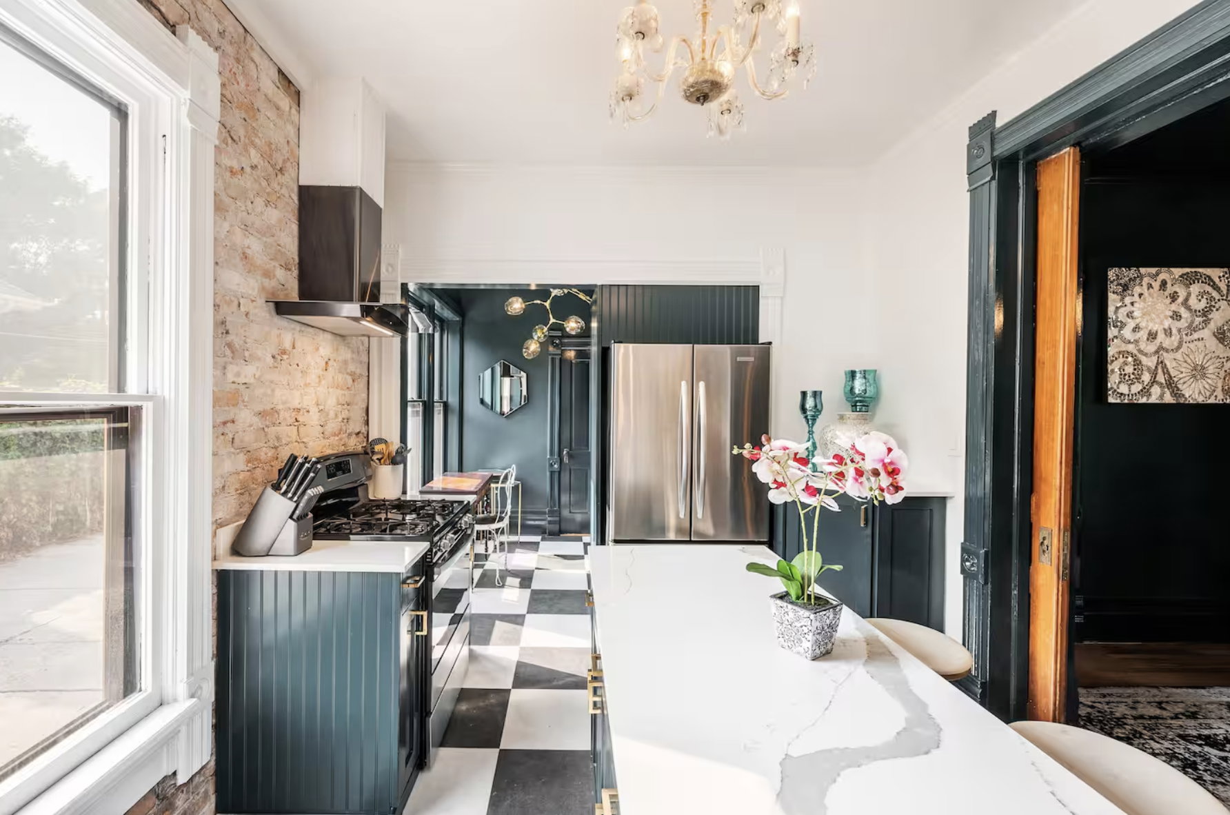 Dining room with suspended lighting and dark flooring