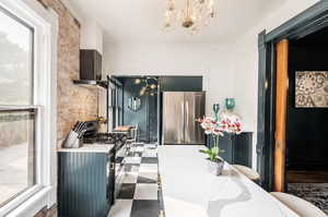 Dining room with suspended lighting and dark flooring