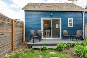 Rear view of house featuring a wooden deck