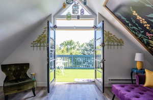 Entryway featuring wood finished floors and a baseboard heating unit