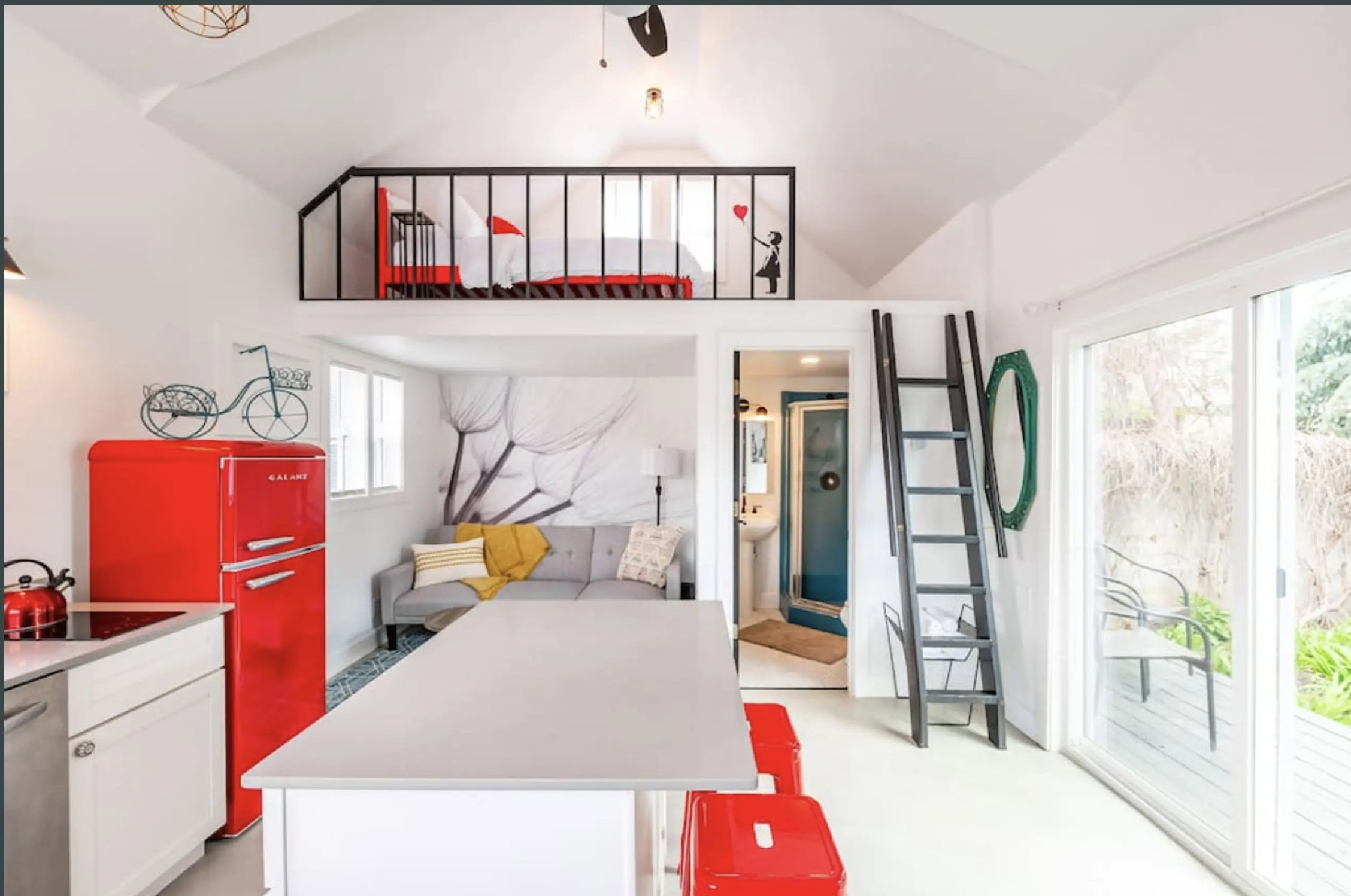 Bedroom featuring freestanding refrigerator, access to outside, vaulted ceiling, a ceiling fan, and connected bathroom
