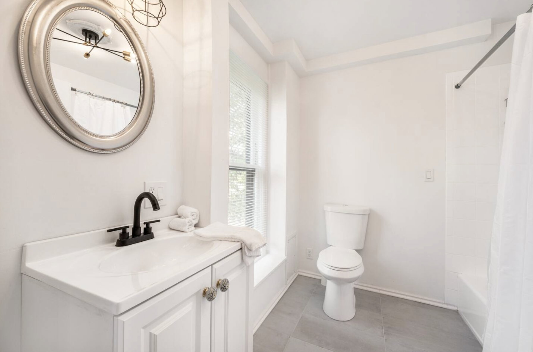 Full bathroom with vanity, shower / tub combo with curtain, and light tile patterned floors