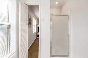 Full bathroom featuring a shower stall, carpet, crown molding, and recessed lighting