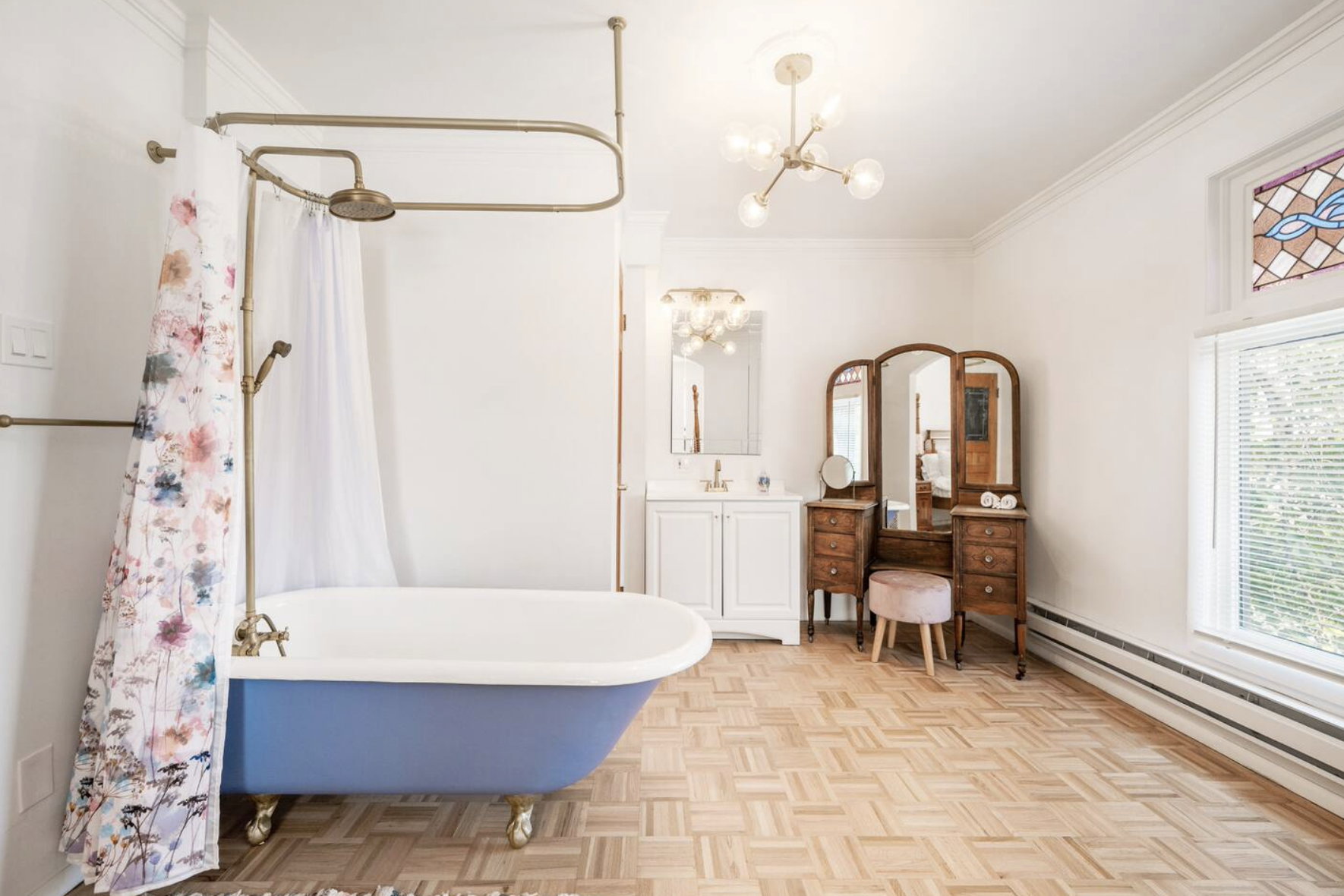 Full bathroom with ornamental molding, parquet floors, vanity, a combined bath / shower with freestanding tub, and a baseboard heating unit