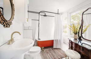 Full bathroom with shower / bath combination with curtain and toilet
