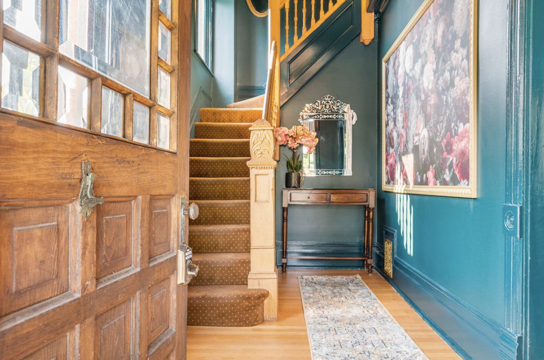 Foyer with stairway and light wood finished floors