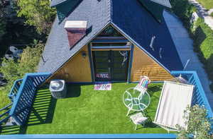 Back of house featuring roof with shingles and french doors