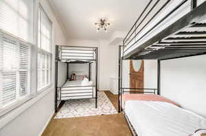 Bedroom featuring light carpet and ornamental molding
