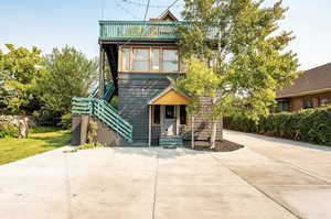 View of front of property featuring concrete driveway