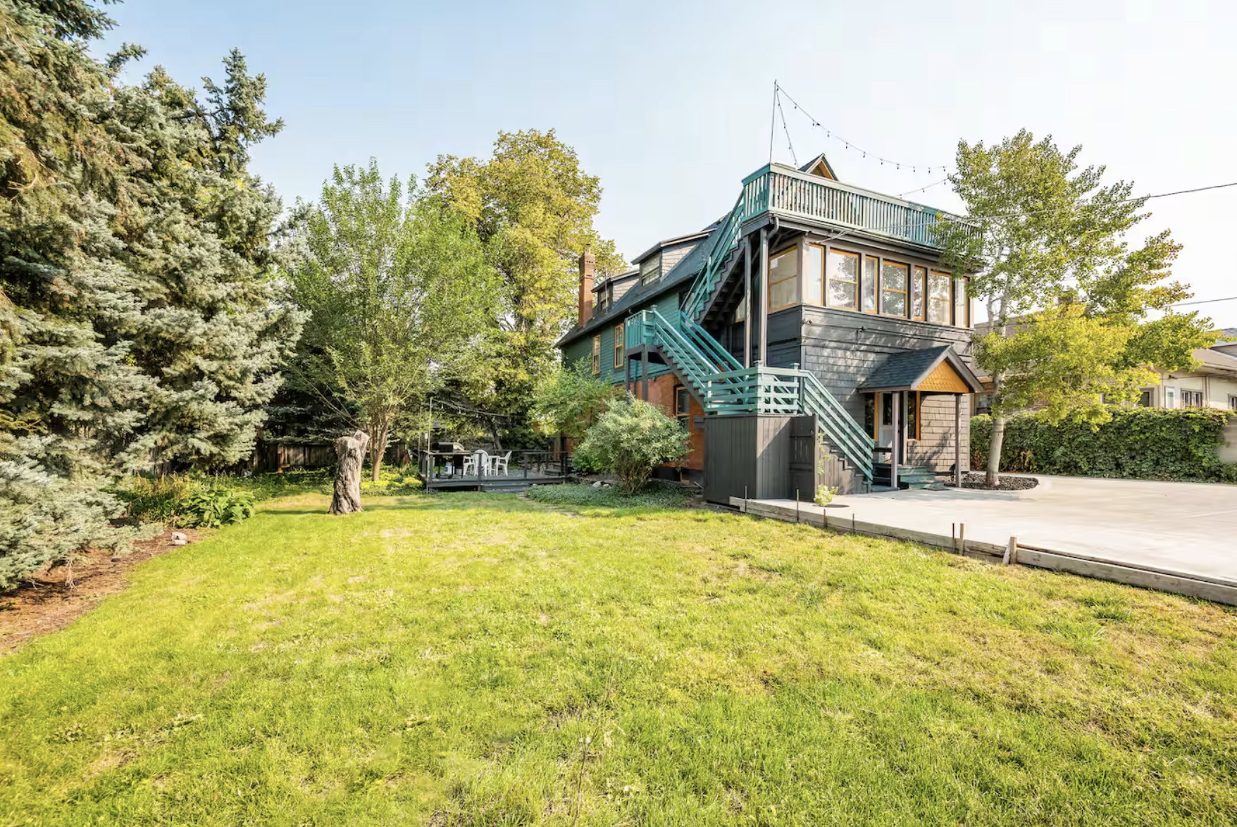 Back of house featuring stairs and a balcony