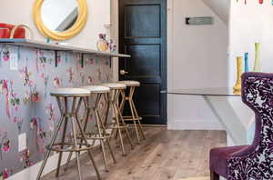 Bar area featuring wood-type flooring and baseboards