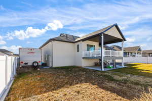Rear view of house with a patio, stucco siding, a deck, and a shingled roof