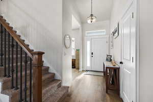 Foyer entrance featuring stairway and wood finished floors