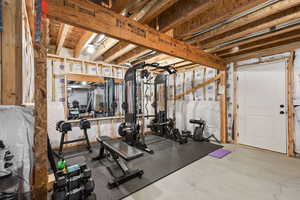 Workout room featuring concrete flooring