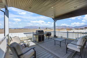 Wooden deck featuring area for grilling and a mountain view