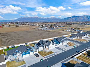 Aerial view of sparsely populated area featuring nearby suburban area and a mountain backdrop
