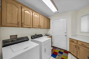 Laundry room with cabinet space and washer and clothes dryer