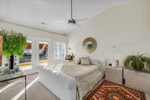 Carpeted bedroom with access to outside, vaulted ceiling, crown molding, and a ceiling fan