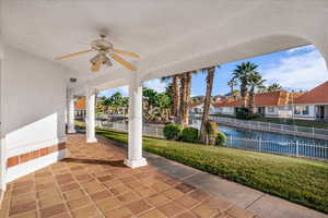 View of patio featuring a ceiling fan and a water view