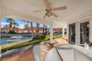 View of patio / terrace featuring outdoor dining area, a ceiling fan, a residential view, and a water view