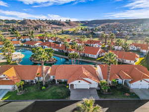 Aerial view of property's location with a nearby body of water and nearby suburban area