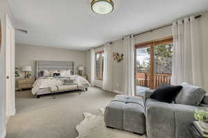 Carpeted bedroom with access to exterior and baseboards