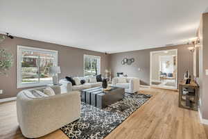 Living room with light wood-style floors and baseboards